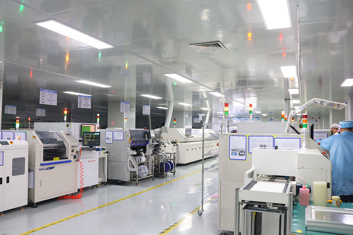PCBA manufacturing workshop with automated assembly equipment and operators