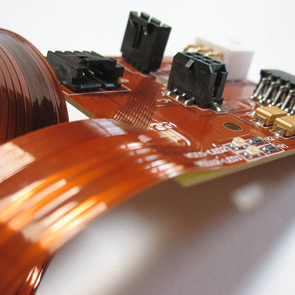 Close-up of components and copper traces on a rigid-flex PCB