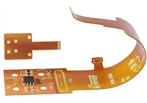 Rigid-flex PCB with populated rigid sections and orange flexible circuit sections