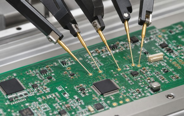 Flying probes contacting electrical test points on a PCB assembly