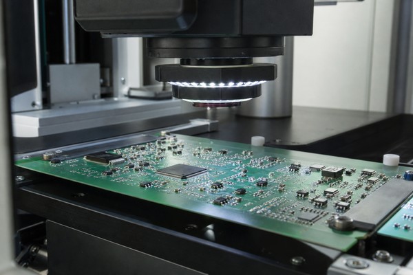 Automated optical inspection equipment checking a PCB assembly