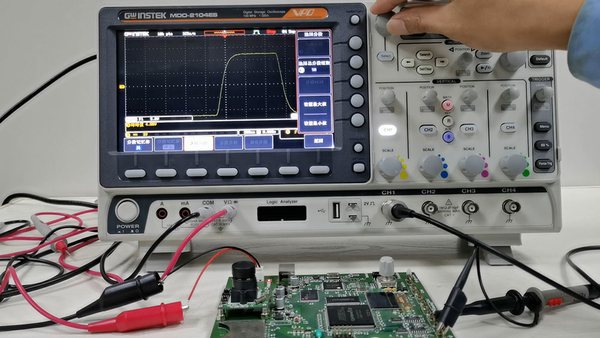 Engineer using an oscilloscope to debug a medical PCBA prototype